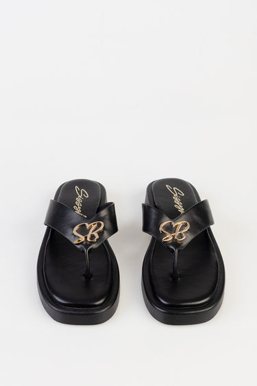 black platform sandals with thong toe post and wide straps featuring a gold SB emblem