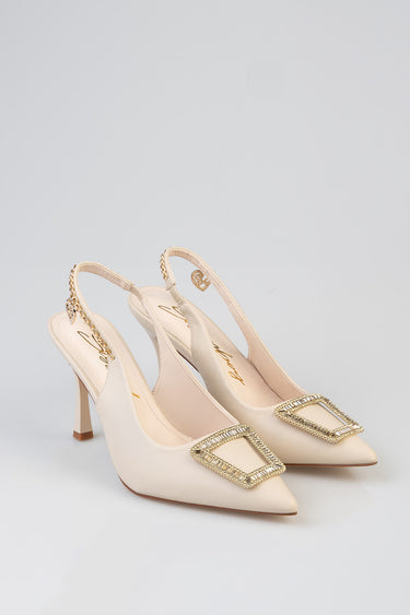 cream slingback heels with pointed toe and a square rhinestone buckle, with a delicate chain ankle strap