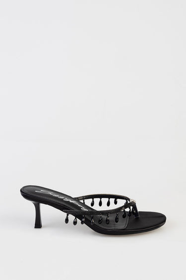 black heeled sandal with a thin beaded toe strap and a small kitten heel