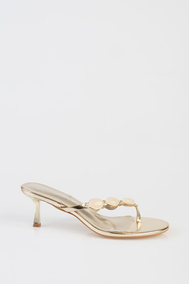 gold metallic heeled sandal with ivory pearl beads along the strap