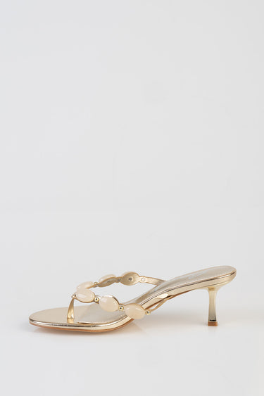 golden heeled sandal with cream bead straps and a slim heel
