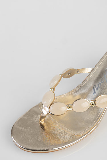 gold metallic sandal with cream beaded strap and small gold accents