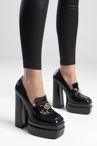black patent platform heels with a gold buckle detail, tall block heel, worn with black leggings