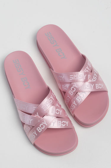 pink slide sandals with crossed satin straps featuring white text across the bands