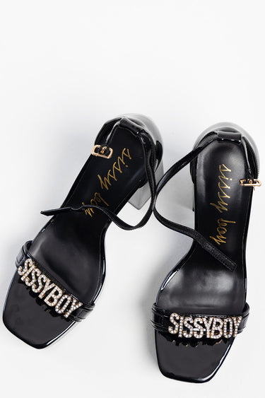 black patent block heel sandals with a rhinestone logo strap reading sissyboy and ankle buckle