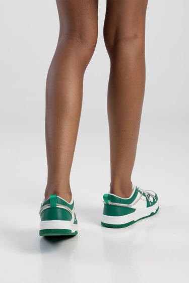 back view of legs wearing green and white sneakers by Blue Jean Traders