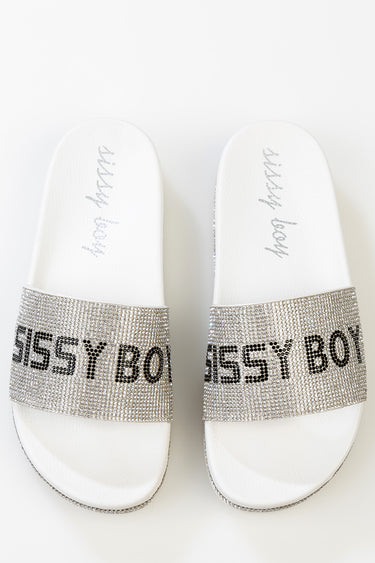 white slide sandals with a silver rhinestone strap featuring bold black lettering across the band by Blue Jean Traders