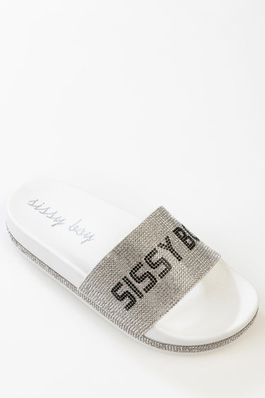 white slide sandal with a wide rhinestone strap across the top and a white contoured footbed.