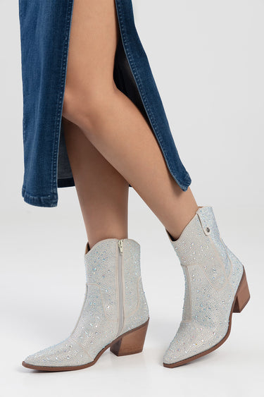 silver sparkly western style ankle boots with a side zipper and a brown stacked heel