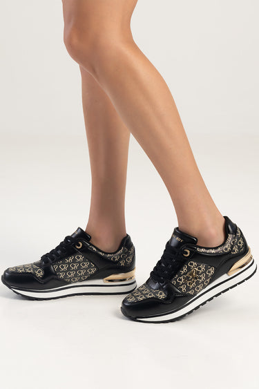 Blue Jean Traders sneakers in black with gold monogram pattern and a white midsole with gold heel accent