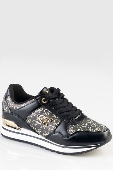 black and cream patterned sneakers with gold logo detailing, black laces, and a white and black chunky sole
