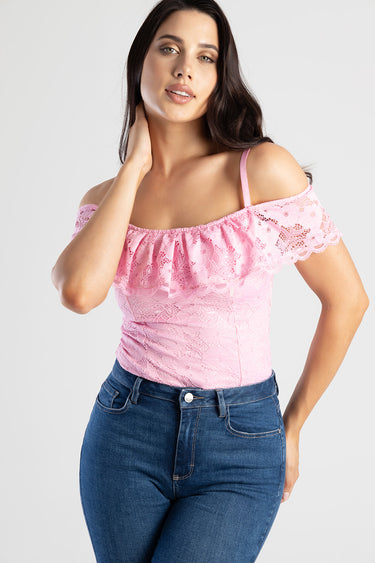 pink lace off the shoulder top with a ruffled neckline and a thin strap on a model wearing blue jeans