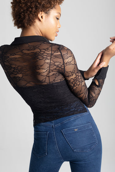 black lace long sleeve blouse with floral pattern on a model wearing blue jeans