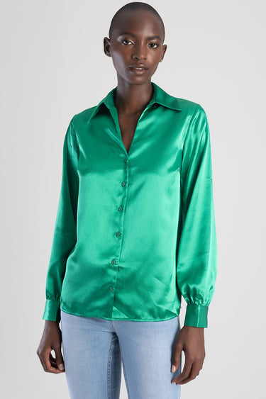emerald green satin blouse with collar, long sleeves, and front buttons on a model wearing light blue jeans