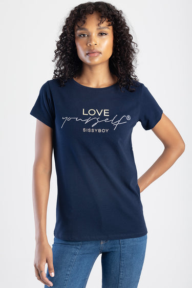 woman wearing navy blue short sleeve top with glitter script reading love yourself and Sissyboy