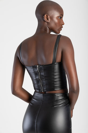 back view of a black leather corset top with wide straps and a silver zipper down the back