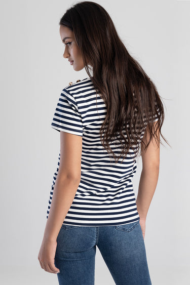 woman wearing navy and white striped short sleeve top viewed from the back with long dark hair, paired with blue jeans