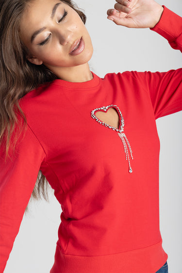 red long sleeve top with a rhinestone heart embellishment and dangling chains