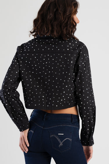 black cropped shirt with silver studs all over, long sleeves, paired with dark blue jeans
