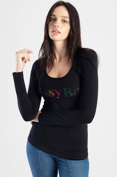 woman modeling a black long sleeve scoop neck top with rainbow rhinestone lettering across the chest with blue jeans