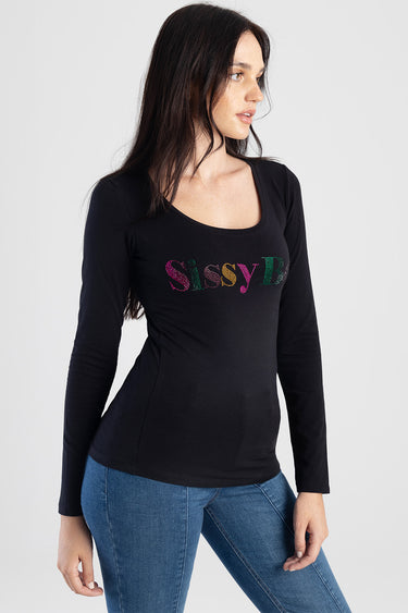 woman wearing black long sleeve top with scoop neck and multicoloured rhinestone lettering on chest