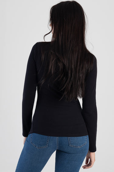 back view of a person wearing a black long sleeve top and blue jeans