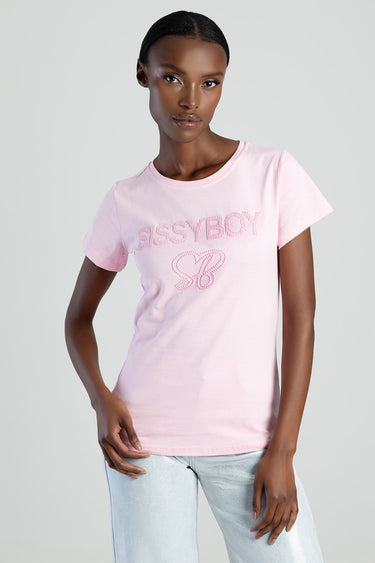 woman wearing a light pink short sleeve top with embroidered sassyboy logo and butterfly motif