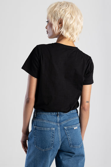 back view of a person wearing a black short sleeve tee and blue denim jeans with back pockets visible