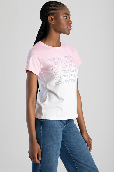 woman wearing a pink and white gradient short sleeve top with a printed repeated text design, paired with blue jeans