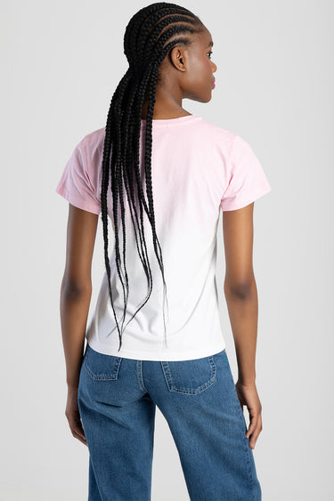 back view of a pink to white gradient short sleeve top worn with blue denim jeans