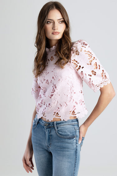 pink floral lace top with scalloped edges and short sleeves, worn by a model with blue jeans