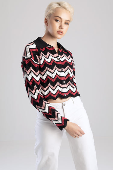 cropped knit sweater with zigzag chevron in black pink white, button front collar, long sleeves, worn by a model