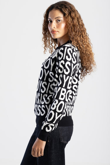 woman in black and white knit sweater with bold repeating letters, side profile