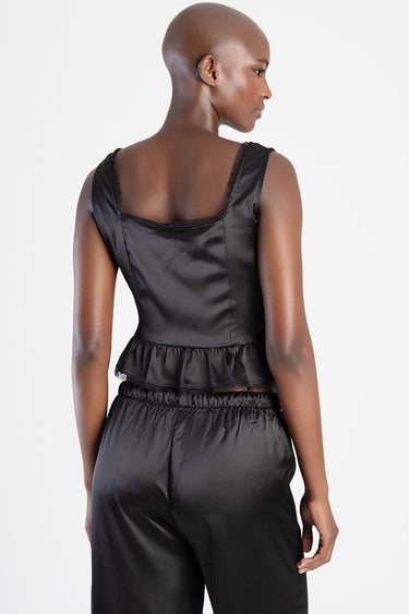 back view of black satin crop top with peplum ruffle and lace trim, paired with satin pants by Blue Jean Traders