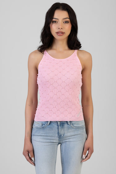 pink sleeveless knit tank top with a pearl bead lattice pattern and tiny pom pom trim, worn with light wash jeans by a model