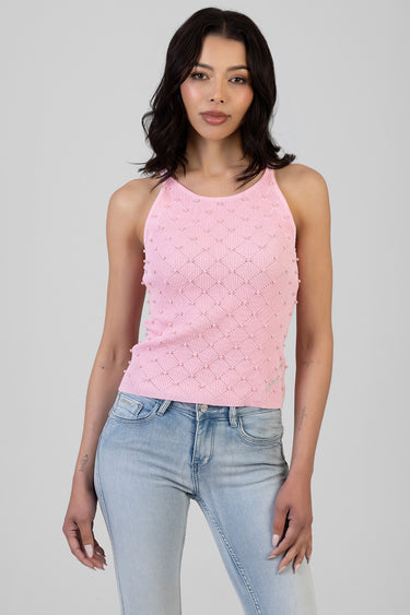 pink sleeveless knit top with pearl bead embellishments on a model wearing light blue jeans