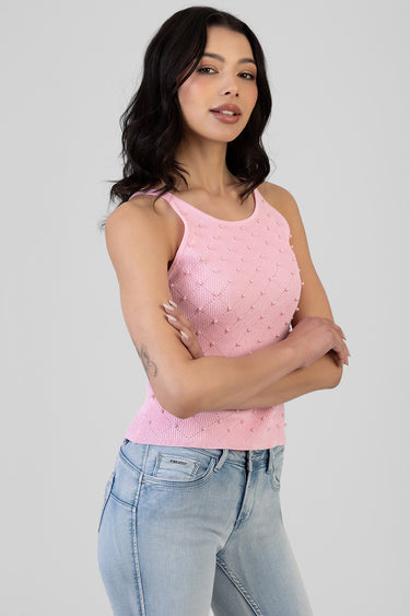 pink knit sleeveless top with pearls by Blue Jean Traders on a model wearing light denim jeans
