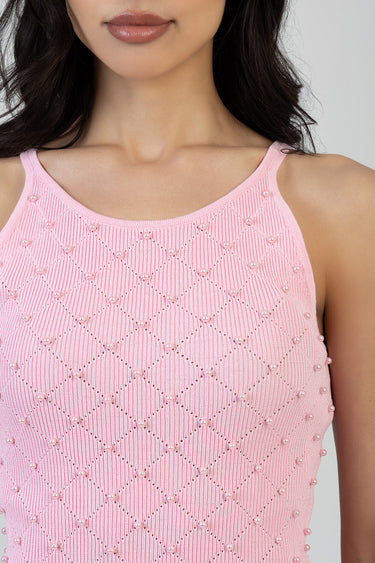 pink knit sleeveless top with pearl beads arranged in a diamond lattice pattern