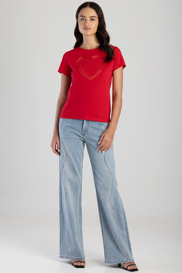woman wearing red short sleeve t shirt with heart embroidery, light wash wide leg jeans with contrast stitching