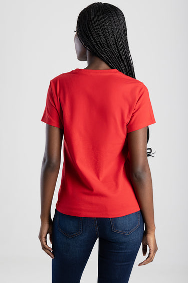 back view of a red short sleeve t shirt with dark wash jeans