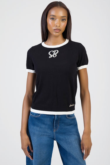 black knit short sleeve top with white trim at neckline and cuffs, rhinestone sb logo on chest and small script logo at hem