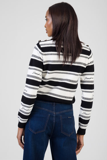 blue jean traders knit sweater with black and white horizontal stripes, worn by a woman, back view