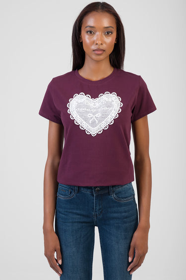woman wearing maroon short sleeve t shirt with large white lace heart graphic