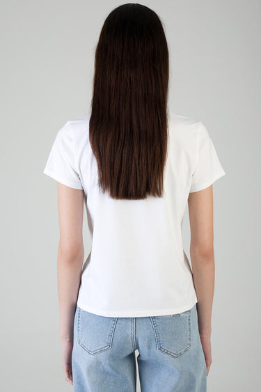 woman wearing white short sleeve t shirt and light wash jeans viewed from behind