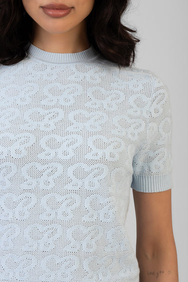 light blue lace knit top with short sleeves and crew neck, model wearing with delicate heart motif