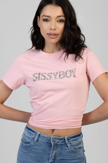 woman in pink cropped short sleeve t shirt with rhinestone Sissyboy lettering, paired with blue denim jeans