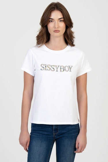 woman wearing white short sleeve t shirt with a glitter logo reading sissyboy on the chest, paired with blue jeans