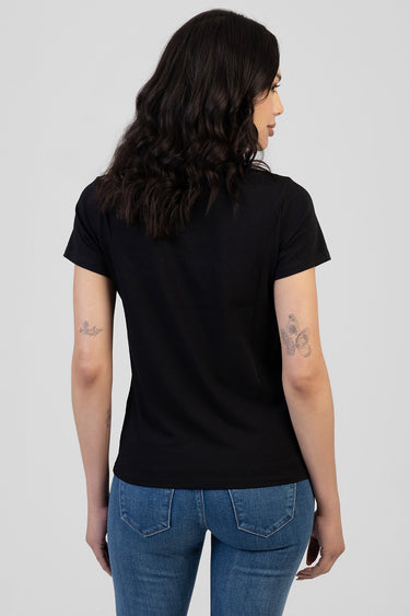 back view of a person wearing a black short sleeve t-shirt and blue denim jeans
