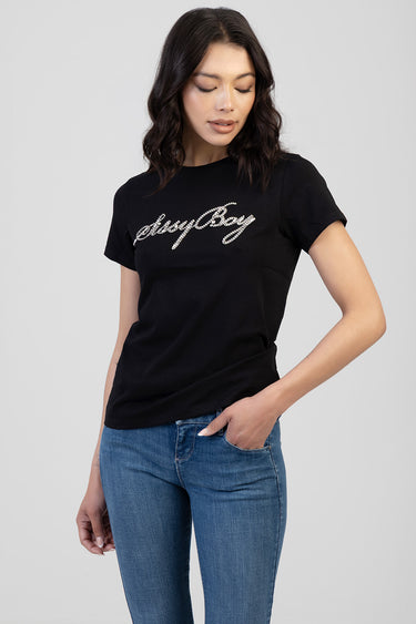woman in black short sleeve tee with sparkling script logo across chest, paired with blue jeans