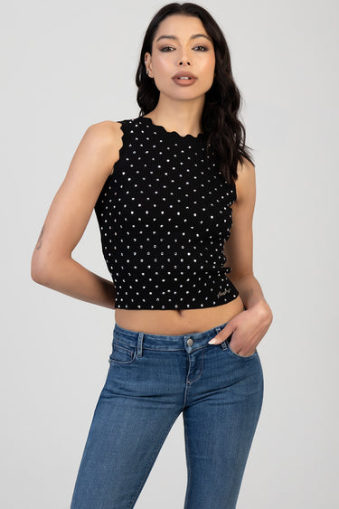 black sleeveless knit top with white polka dots, scalloped neckline, cropped length, shown with blue jeans